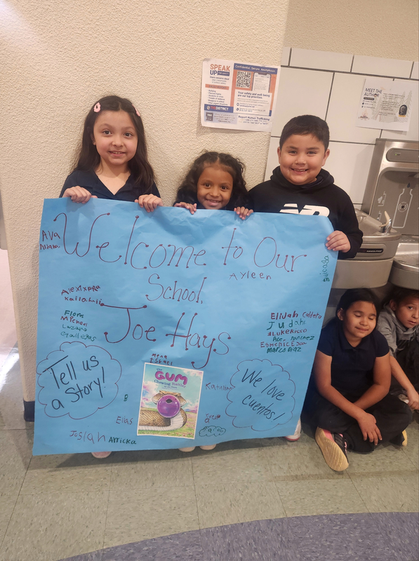 Ms. Guerrero's students holding a welcome sign for Joe Hayes