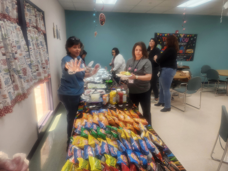 Ms. Romero getting her lunch served by a CVC volunteer