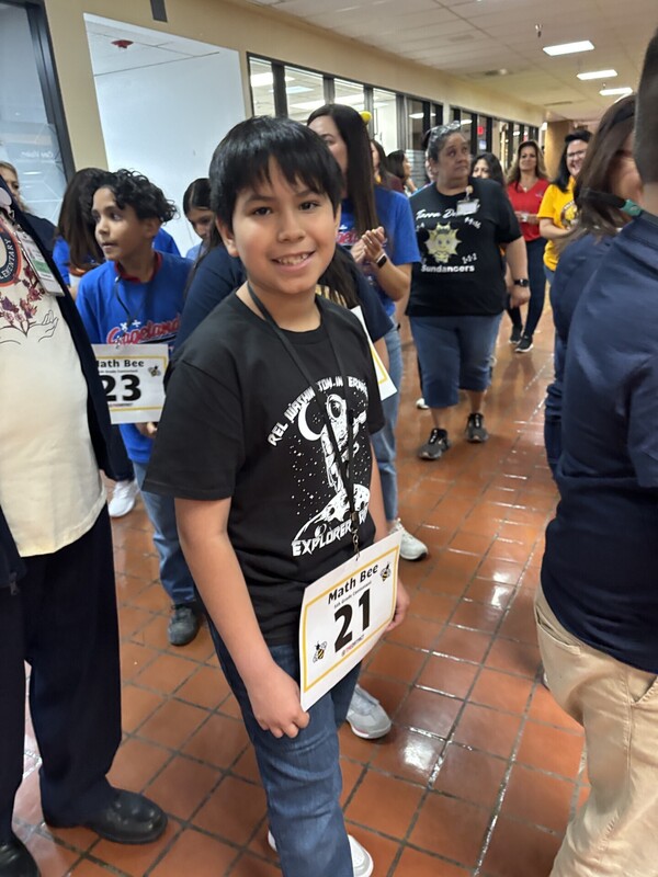 5th grade participant wearing his participant number ready for competition at the District's math bee