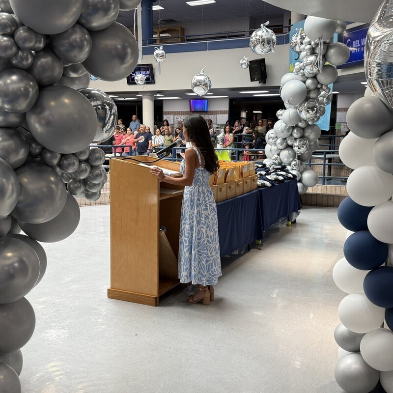 Awards ceremony presenter at podium in DVHS commons