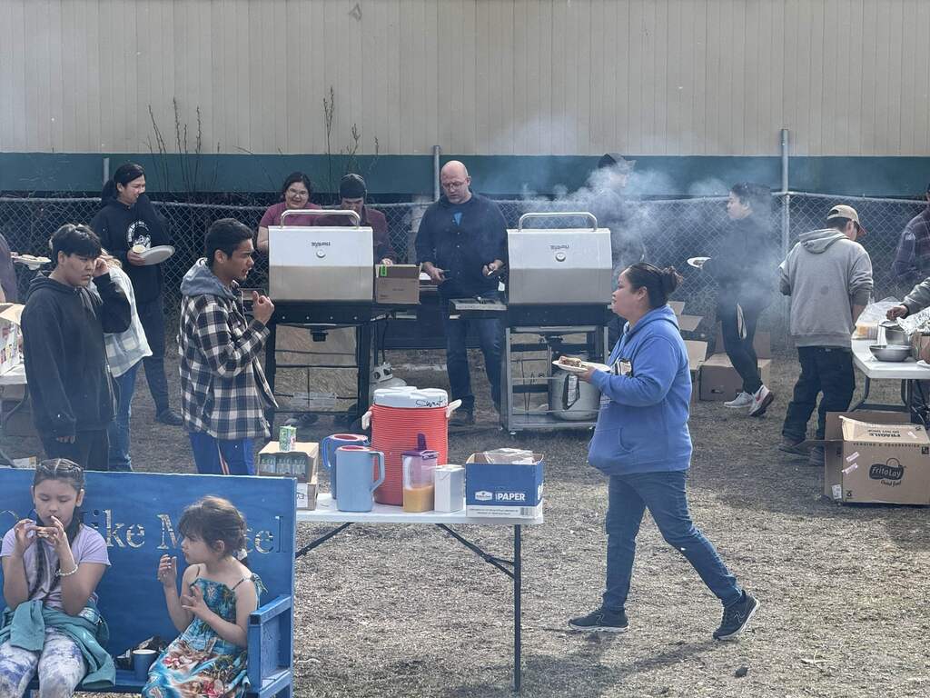 Adults grilling at a cookout