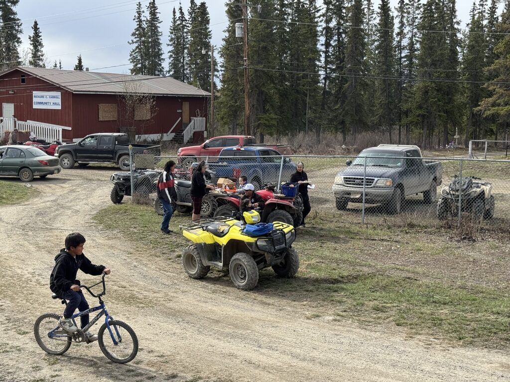 Boy on a bike with vehicles in the background