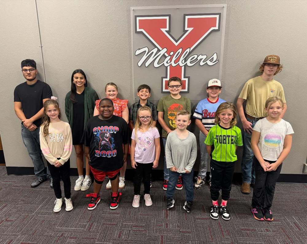 group of kids together smiling in front of logo