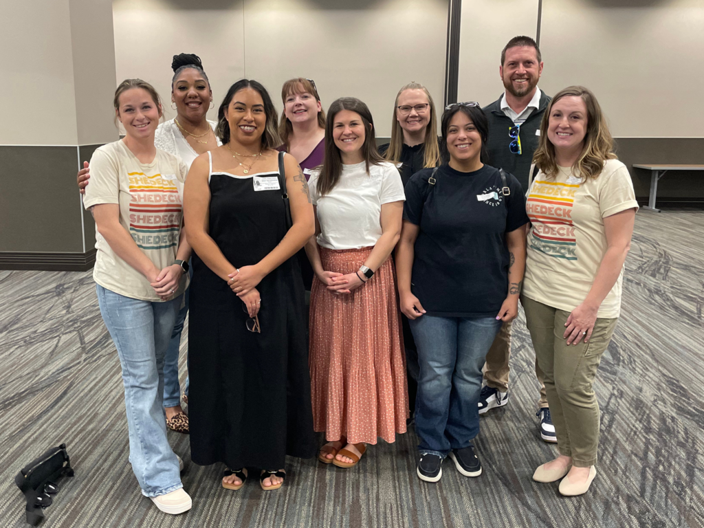 Group photo of Shedeck Helping Hand volunteers, PTO President, and Principal