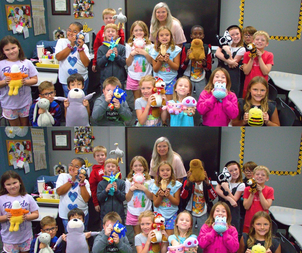 Students holding their stuffed animals in a group