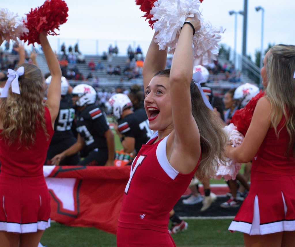 Student cheering on the football field