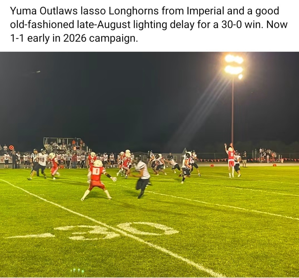 Nighttime football game on a field. Players in red and white jerseys. Text overlays with scores and season information.