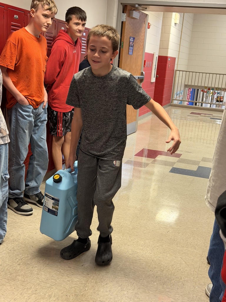 Each student took turns carrying the jug down the hall and back.