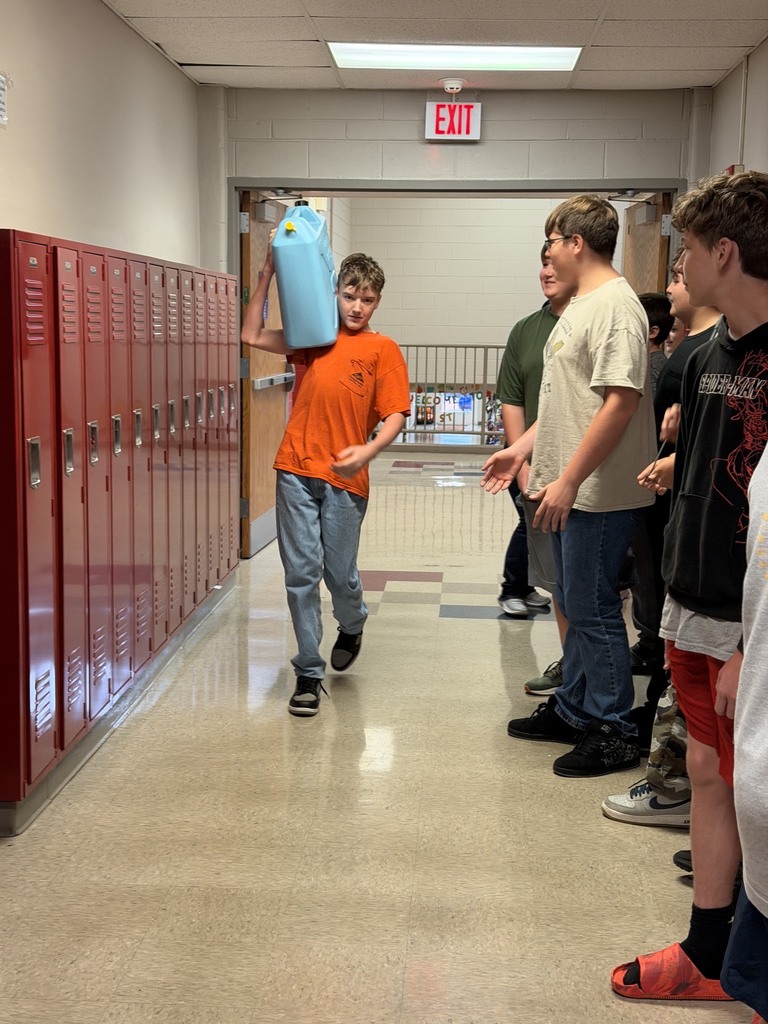 The students attempted to carry the five gallon can of water in various ways.
